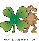 Big Cat Cartoon Vector Clipart of a Brown Cougar Mascot Character with a Clover by Mascot Junction